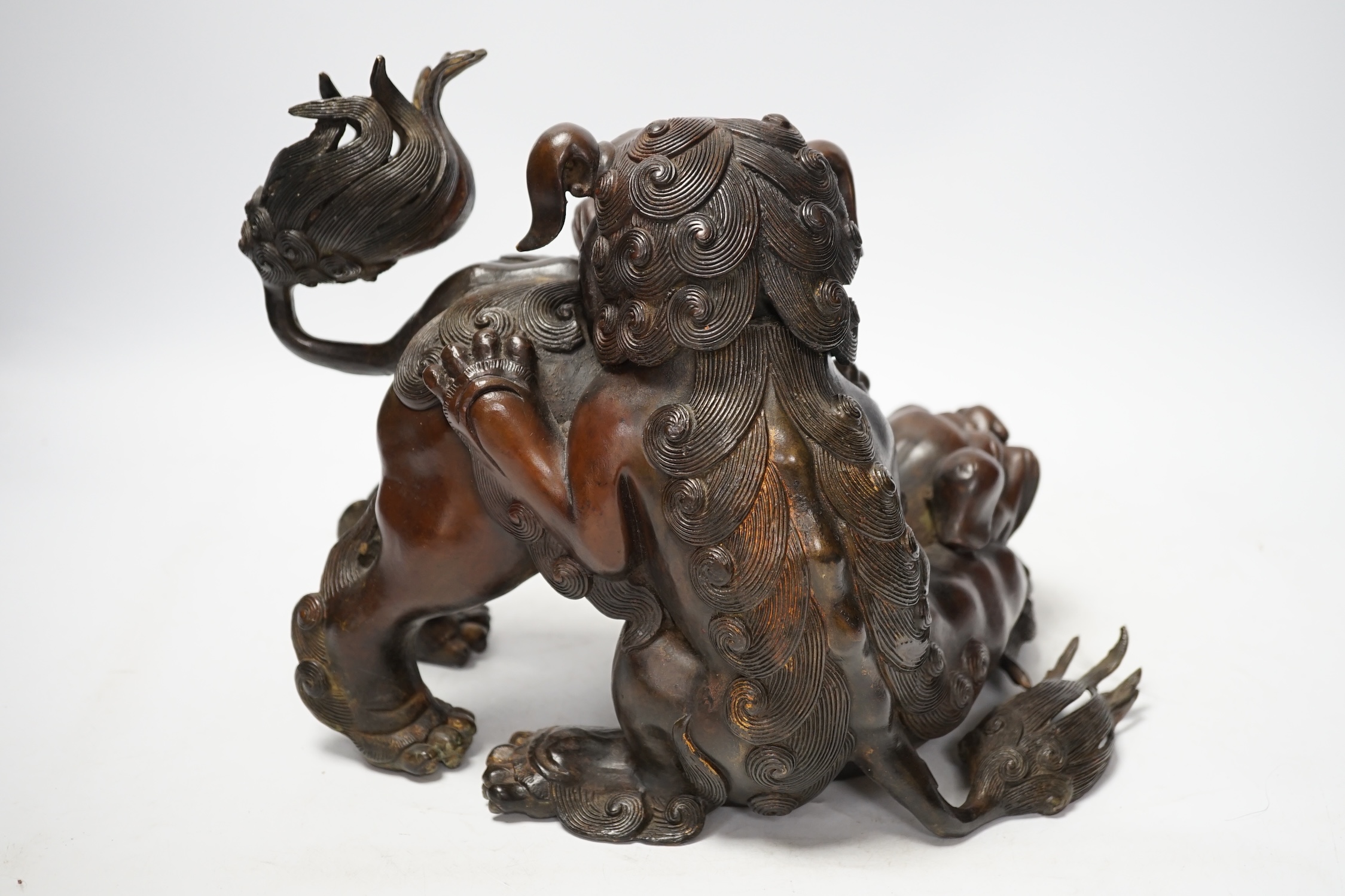 A large Chinese bronze incense burner, modelled as 2 lion dogs playing, 19th century, 22cm high. Condition - good